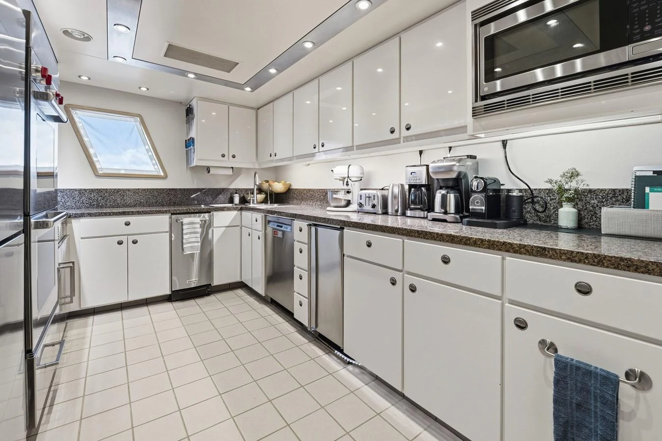 a kitchen with white cabinets aboard STAMPEDE Yacht for Sale