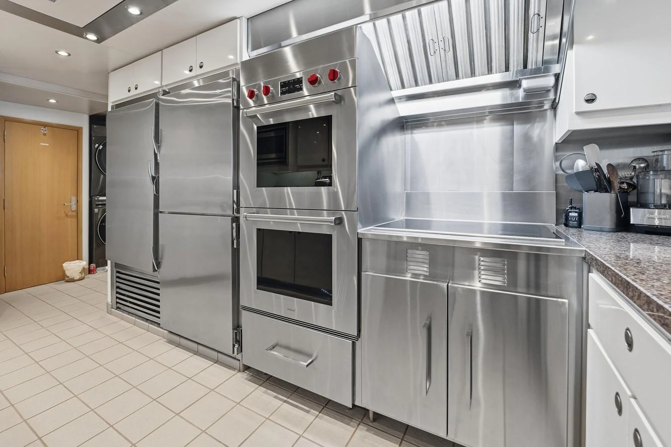 a kitchen with stainless steel appliances aboard STAMPEDE Yacht for Sale
