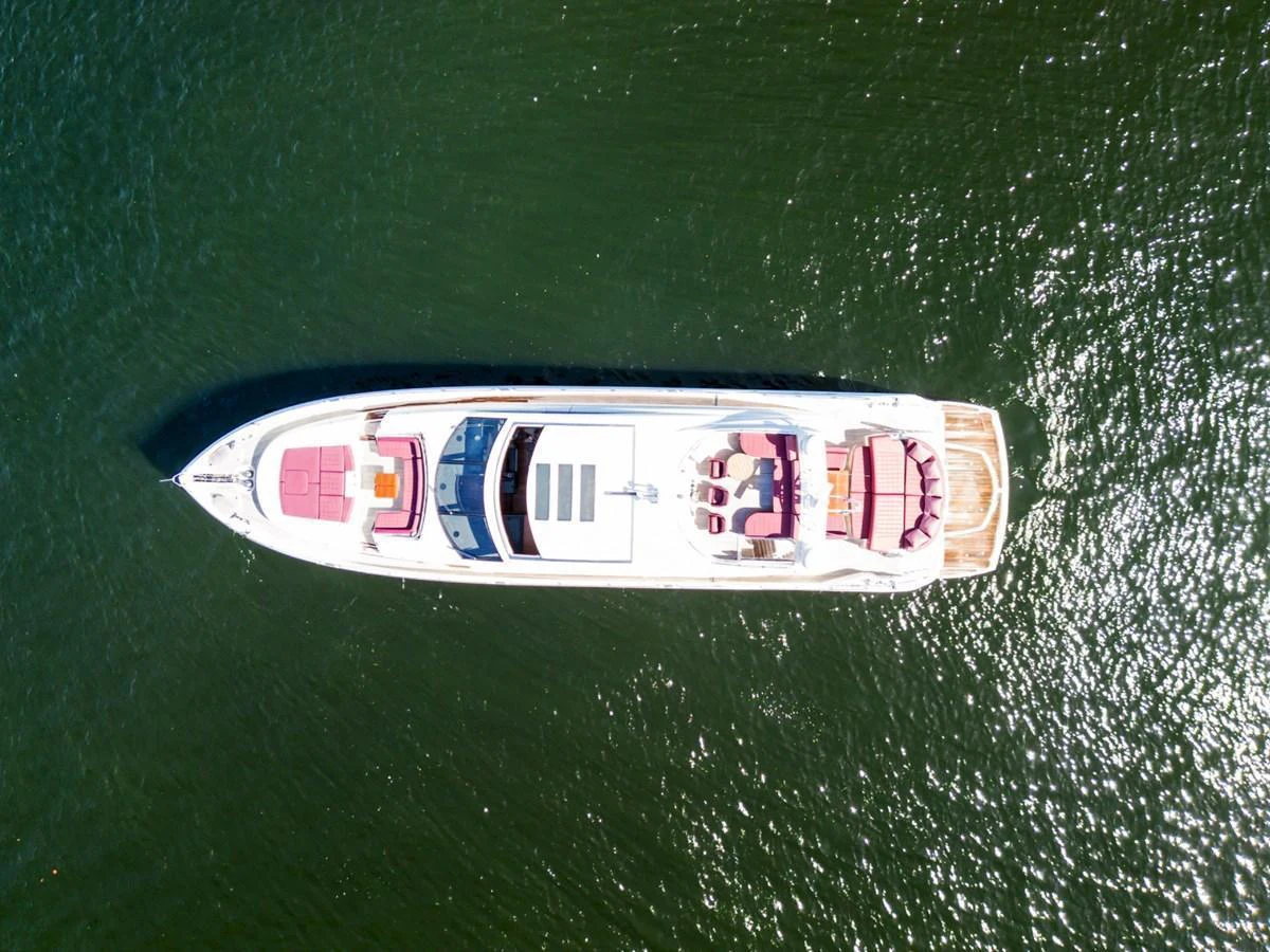 An aerial view of a sleek yacht cruising on calm waters. aboard GBXSK84PRD13 Yacht for Sale