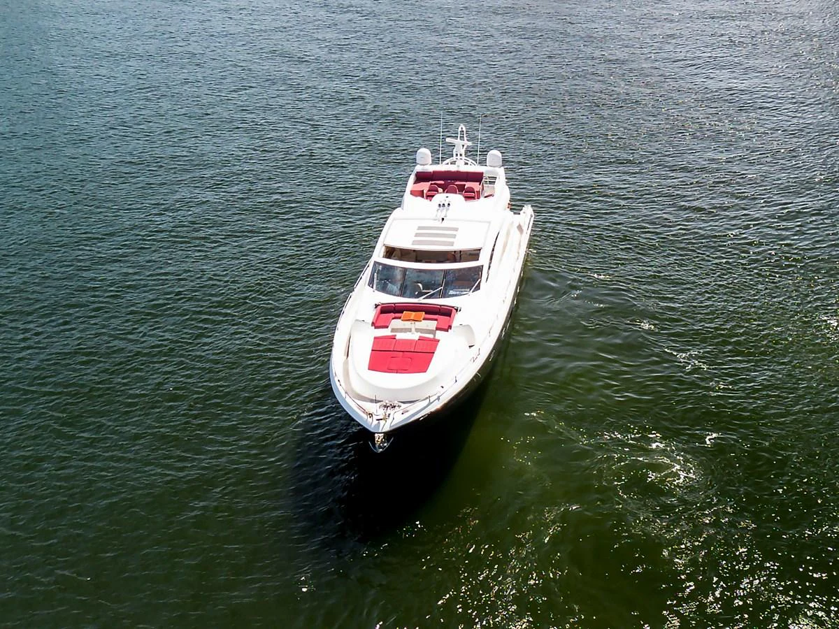 A sleek yacht cruises gracefully on calm waters, showcasing its elegant design and spacious deck. aboard GBXSK84PRD13 Yacht for Sale