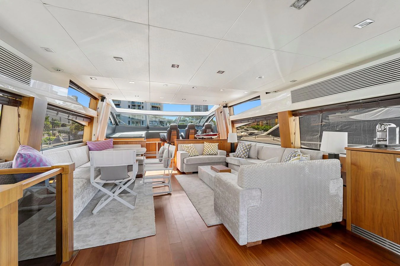 The spacious salon features luxurious seating and panoramic windows for an elegant and comfortable experience. aboard GBXSK84PRD13 Yacht for Sale