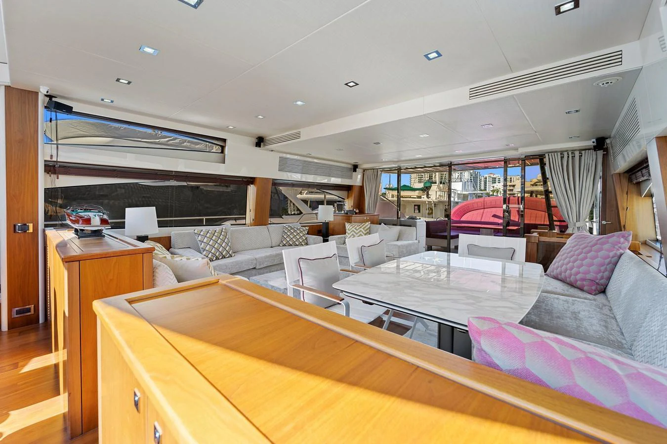 The spacious salon features elegant seating and ample natural light, creating a welcoming atmosphere. aboard GBXSK84PRD13 Yacht for Sale