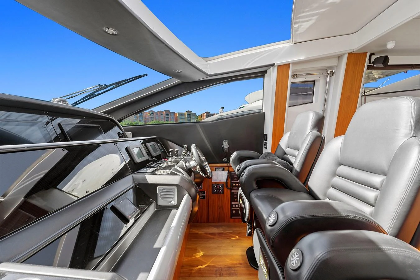 The helm station features luxurious seating and state-of-the-art navigation equipment. aboard GBXSK84PRD13 Yacht for Sale