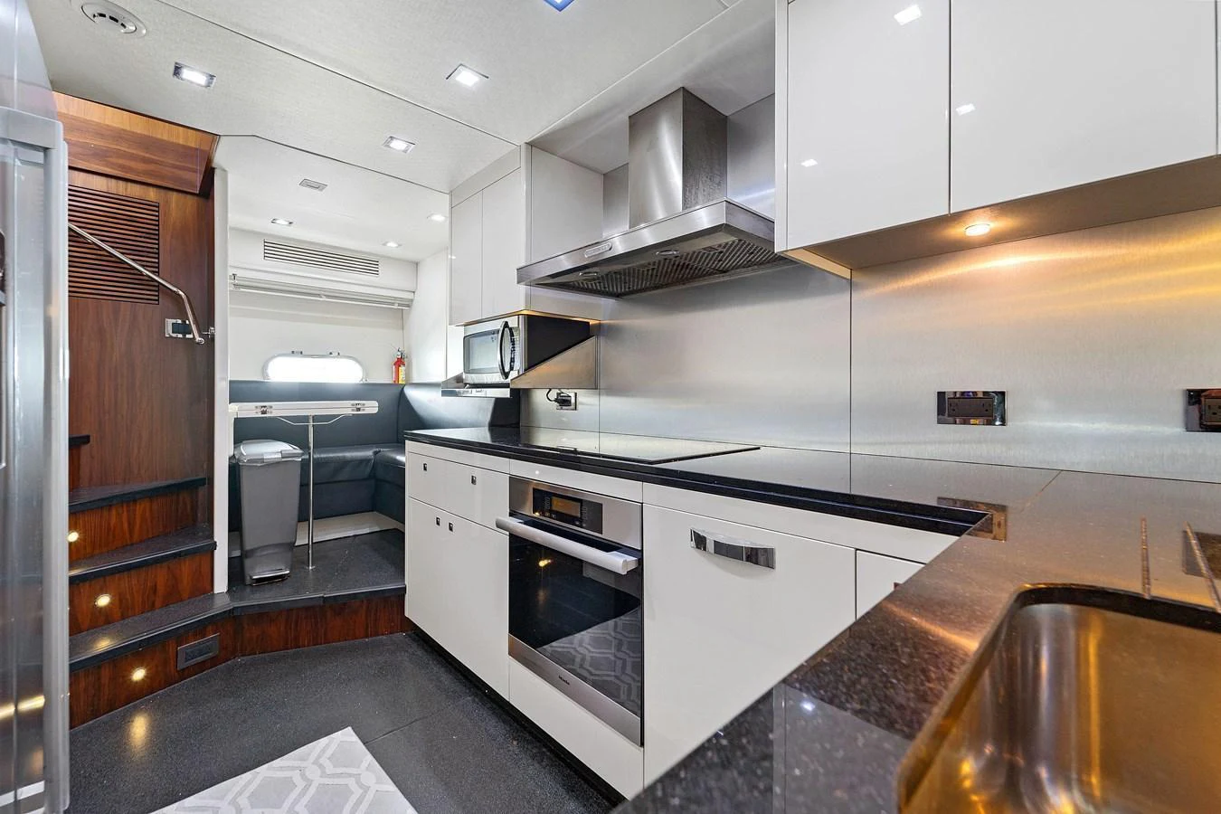 The yacht's galley features modern appliances and sleek cabinetry for a luxurious cooking experience. aboard GBXSK84PRD13 Yacht for Sale