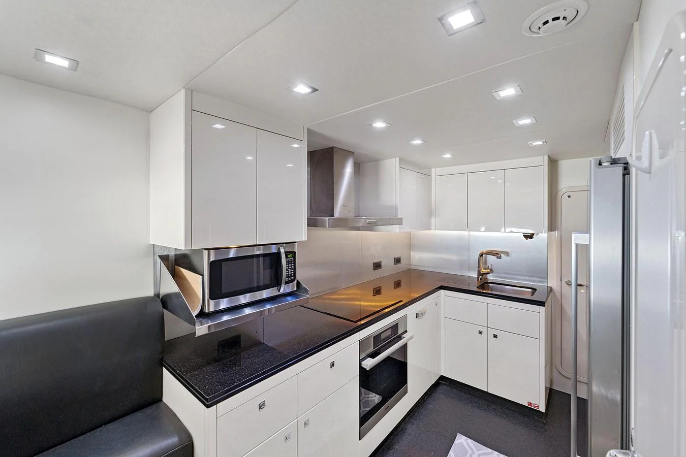 The yacht's galley is equipped with modern appliances and sleek cabinetry, offering a clean and functional space for meal preparation. aboard GBXSK84PRD13 Yacht for Sale