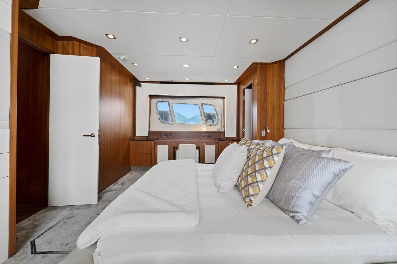 The master stateroom features a luxurious bed with plush pillows and elegant wood paneling. aboard GBXSK84PRD13 Yacht for Sale