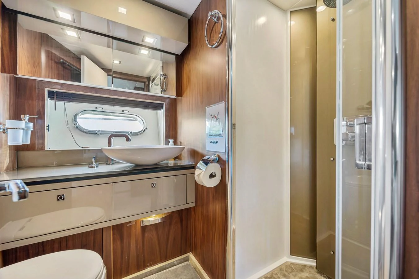 The yacht's bathroom features modern fixtures and a sleek design with wood accents. aboard GBXSK84PRD13 Yacht for Sale