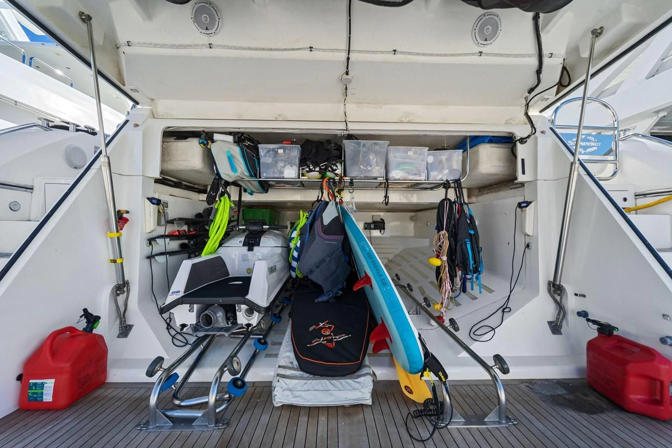 The yacht's storage area is well-organized with various water sports equipment and gear. aboard GBXSK84PRD13 Yacht for Sale
