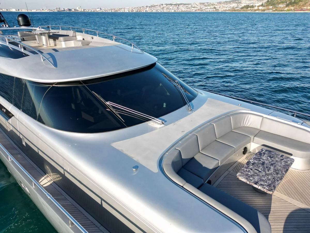 The sleek foredeck of the yacht features a spacious seating area with a modern design. aboard SPECTRE Yacht for Sale
