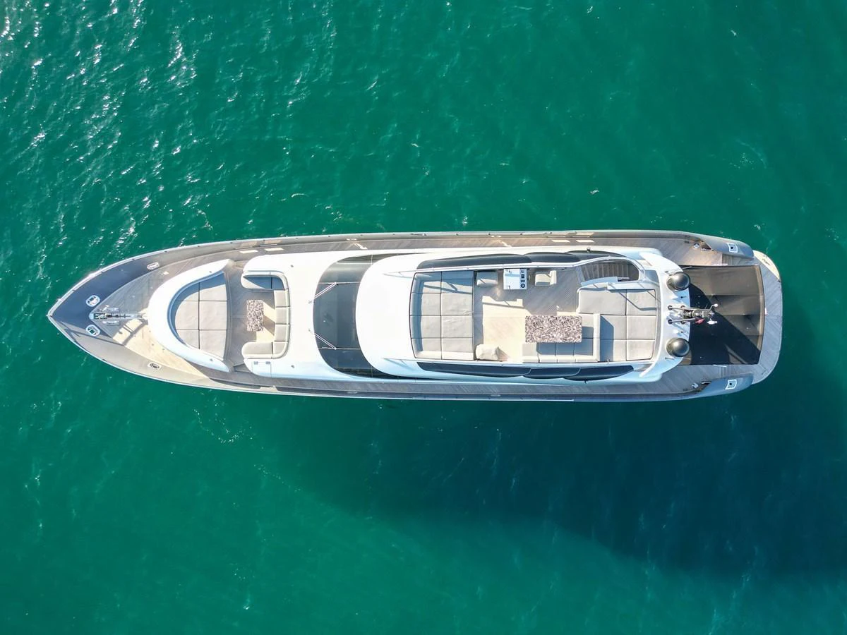 A sleek yacht is captured from an aerial view, showcasing its streamlined design and spacious deck areas. aboard SPECTRE Yacht for Sale
