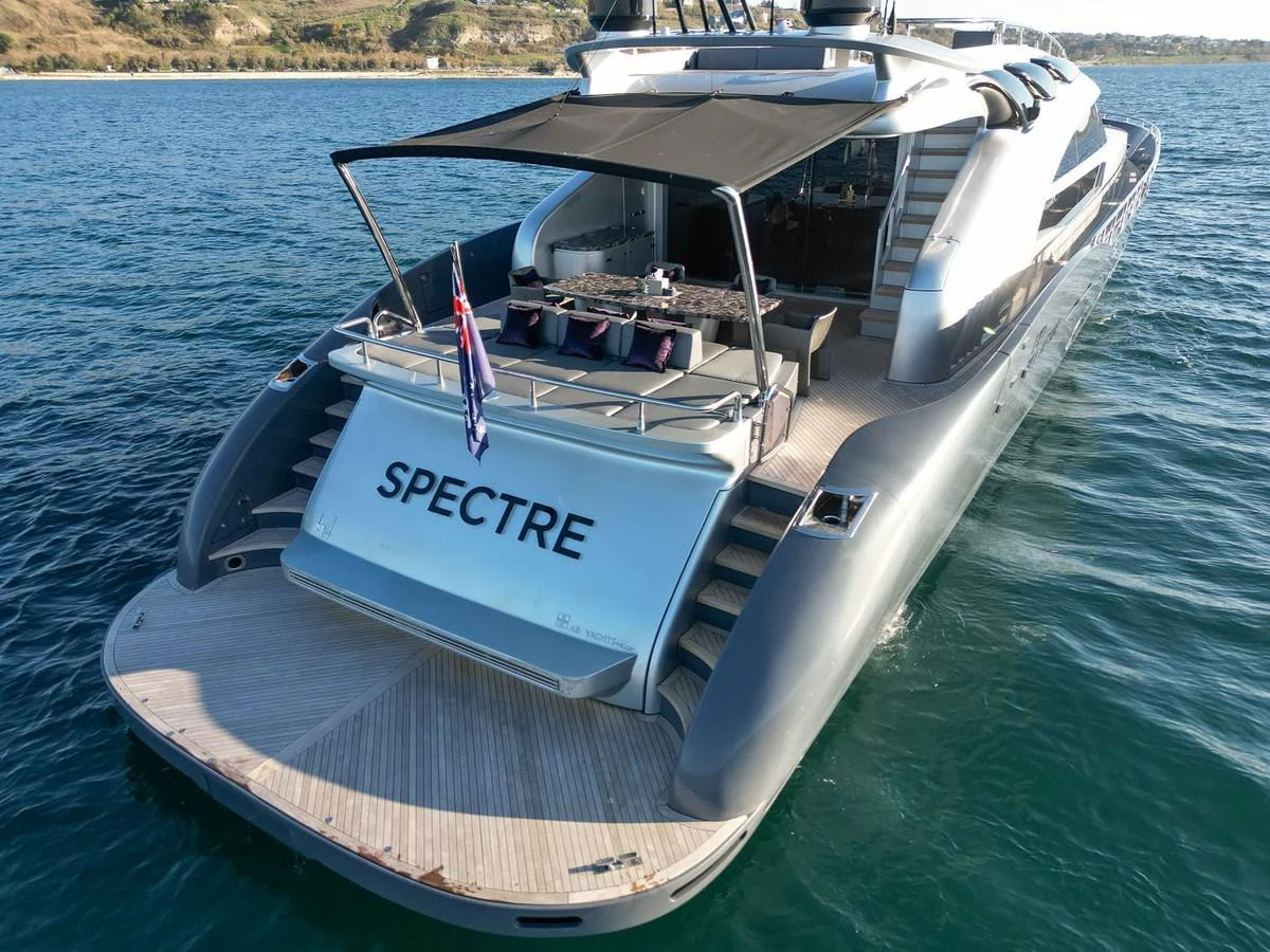 The yacht's sleek aft deck features a spacious lounging area and elegant design, perfect for relaxation on the water. aboard SPECTRE Yacht for Sale