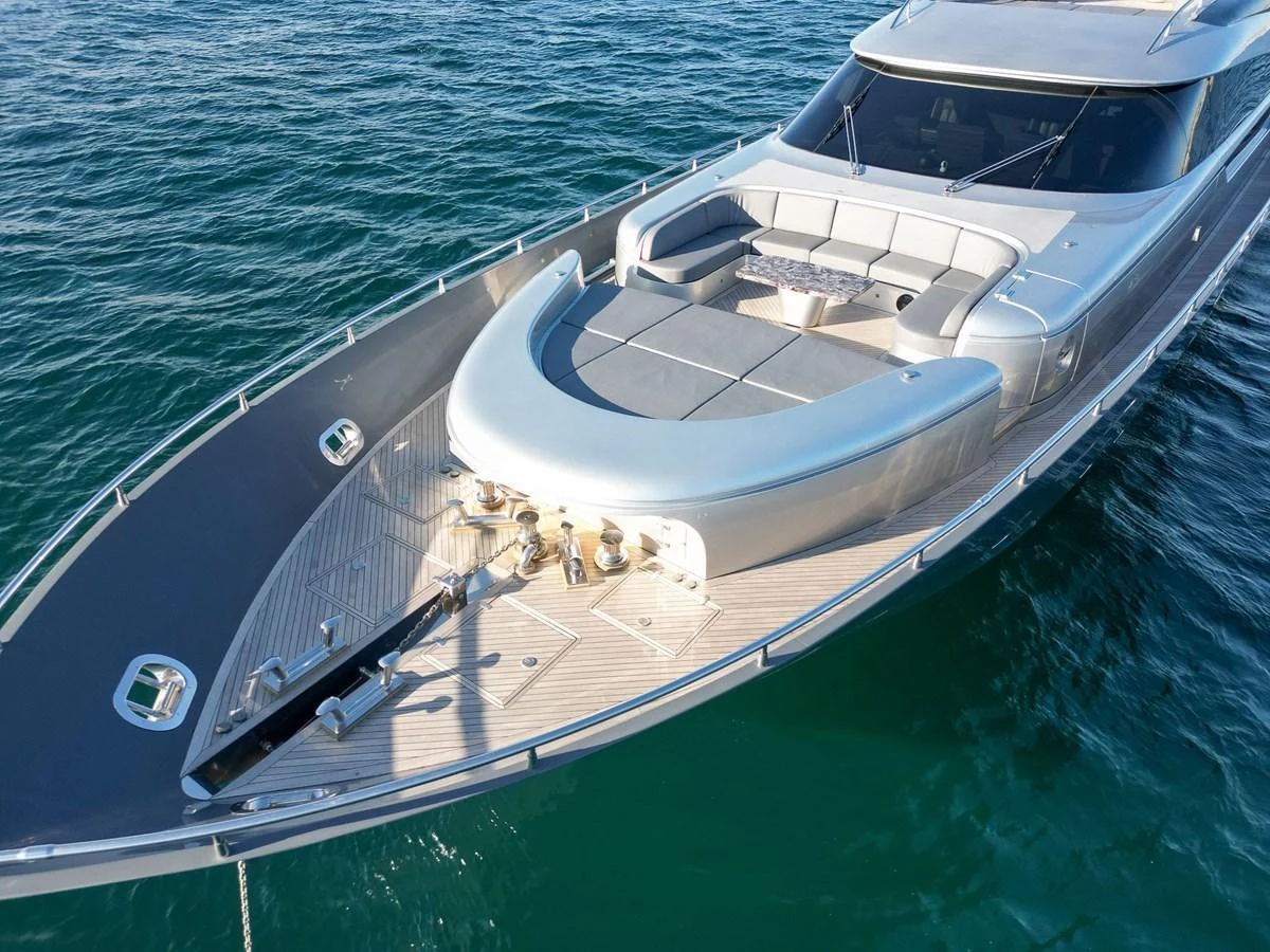 The yacht's foredeck features a spacious sunbathing area with plush seating and sleek design elements. aboard SPECTRE Yacht for Sale
