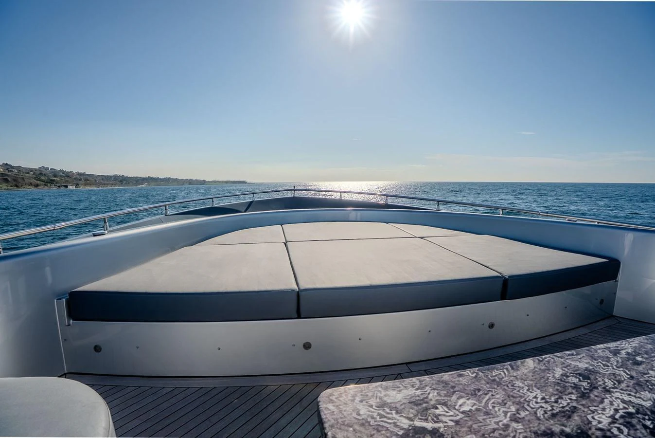 The yacht's foredeck features a spacious sunpad area with stunning ocean views. aboard SPECTRE Yacht for Sale