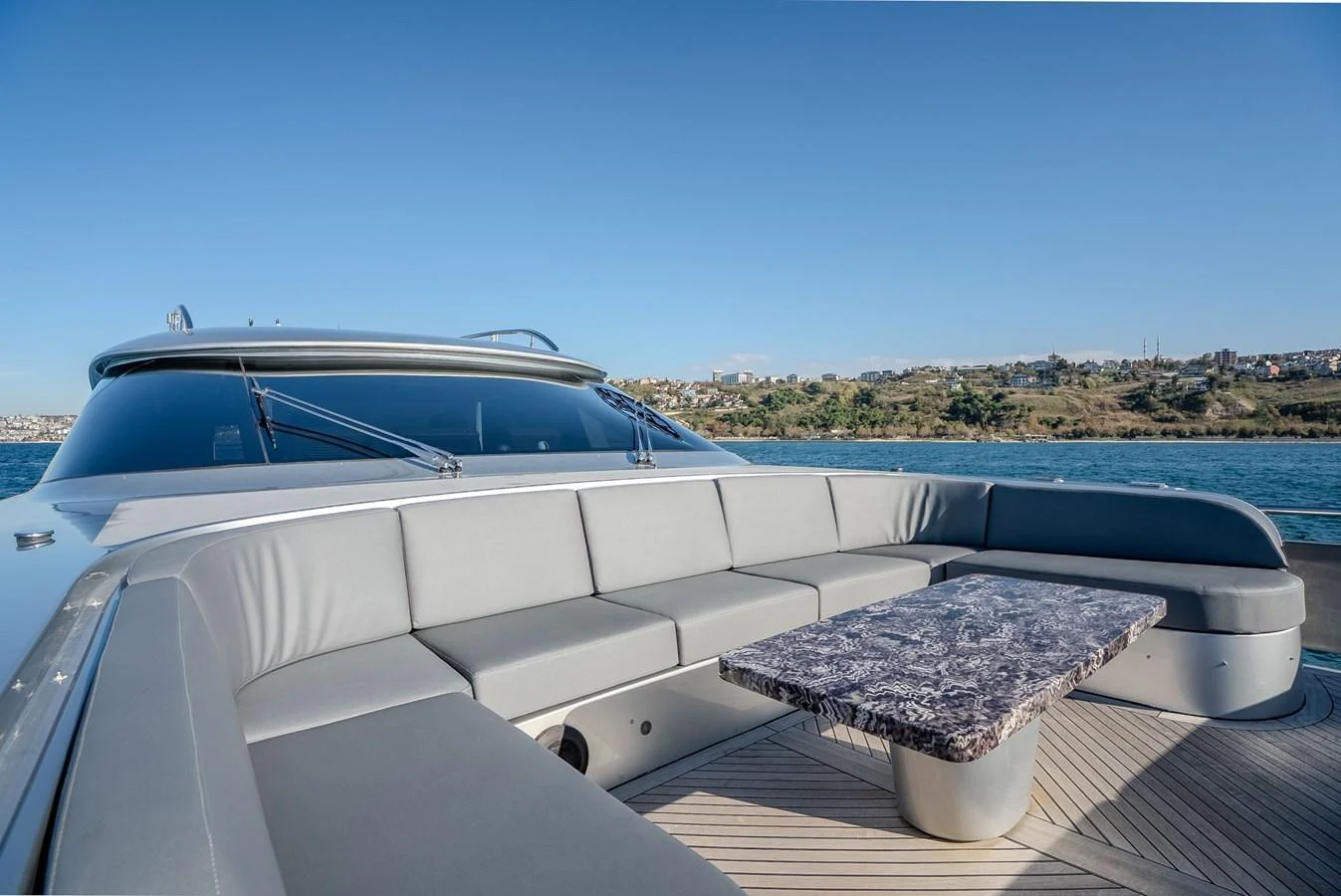 The yacht's foredeck features a spacious seating area with a stylish table, perfect for relaxation and socializing. aboard SPECTRE Yacht for Sale