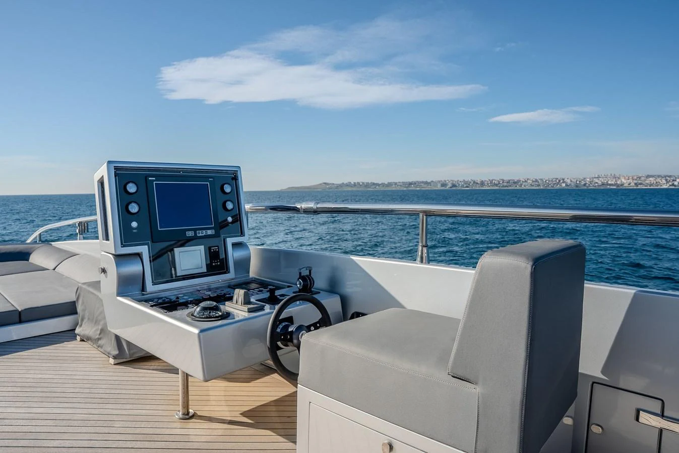 The yacht's helm station offers a modern and sleek design with a stunning ocean view. aboard SPECTRE Yacht for Sale