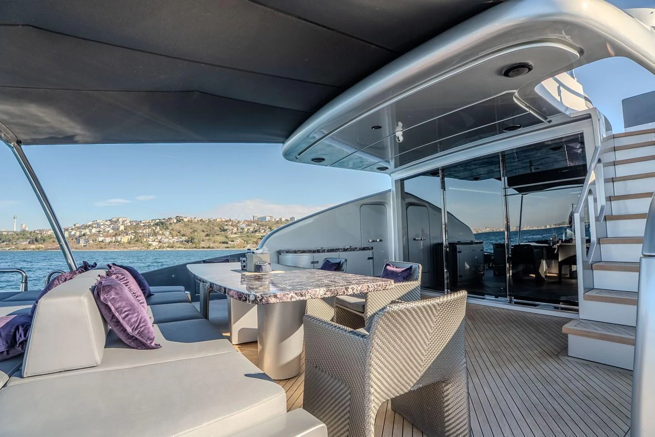 The aft deck offers a luxurious outdoor dining area with comfortable seating and stunning views. aboard SPECTRE Yacht for Sale