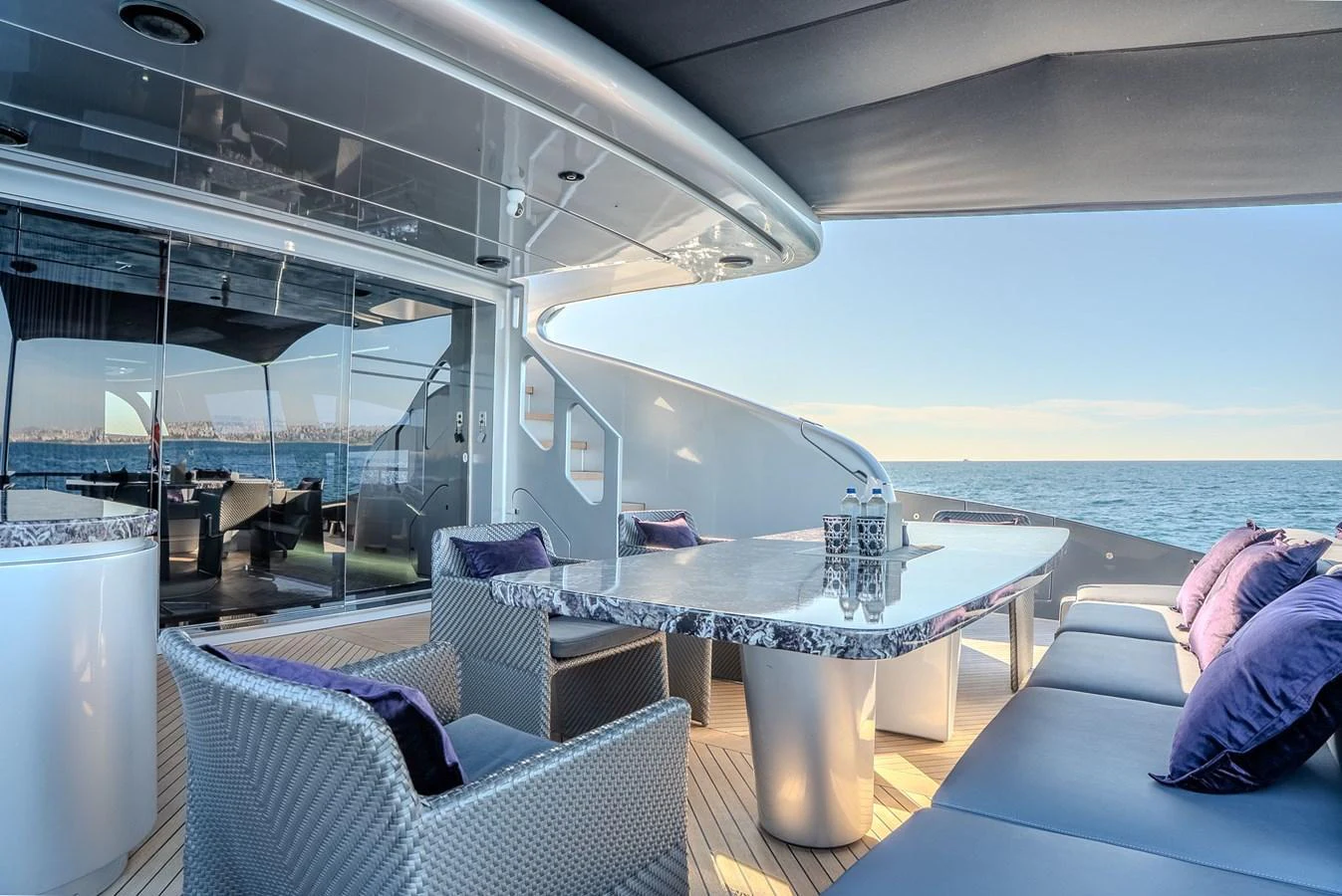 The aft deck offers a luxurious outdoor dining area with stunning ocean views. aboard SPECTRE Yacht for Sale