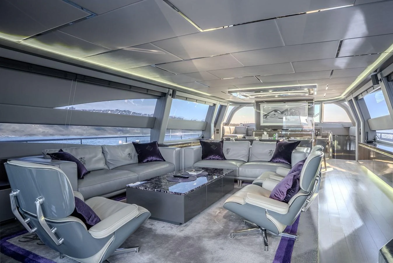 The yacht's salon features modern furnishings with ample seating and panoramic windows. aboard SPECTRE Yacht for Sale