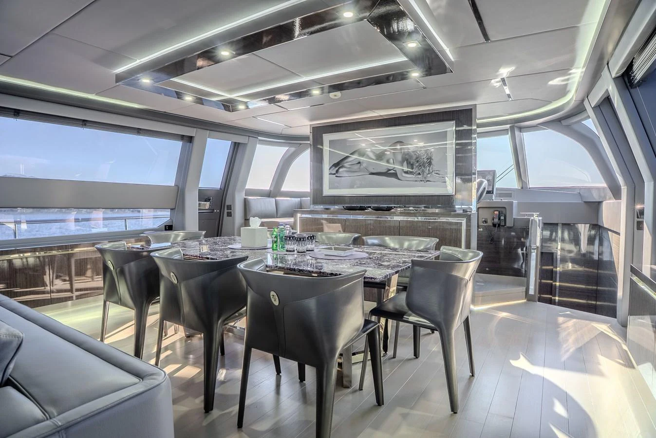 The yacht's dining area features modern furnishings and expansive windows, offering a luxurious and bright setting for meals. aboard SPECTRE Yacht for Sale