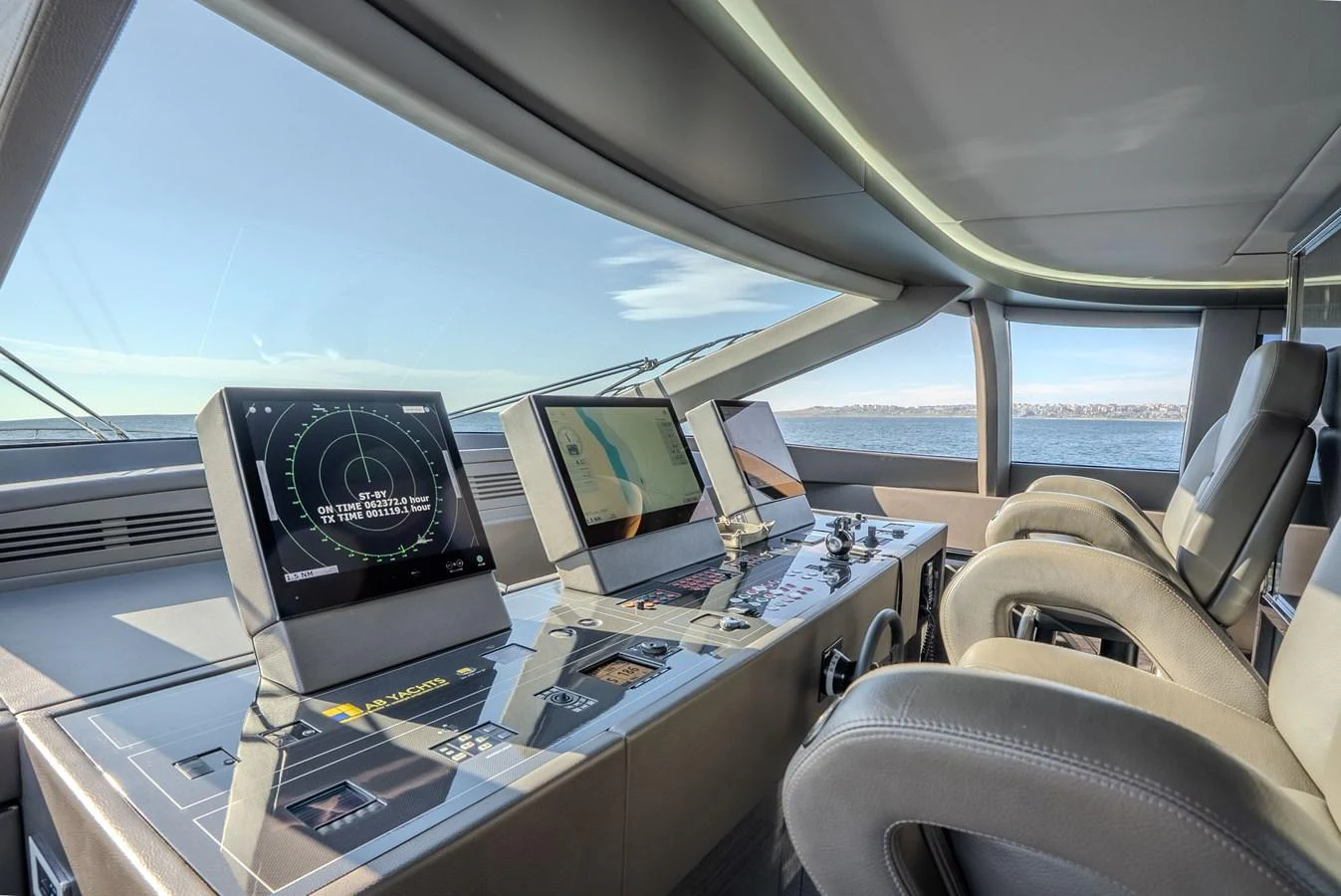 The helm station features advanced navigation equipment and luxurious seating with panoramic views. aboard SPECTRE Yacht for Sale