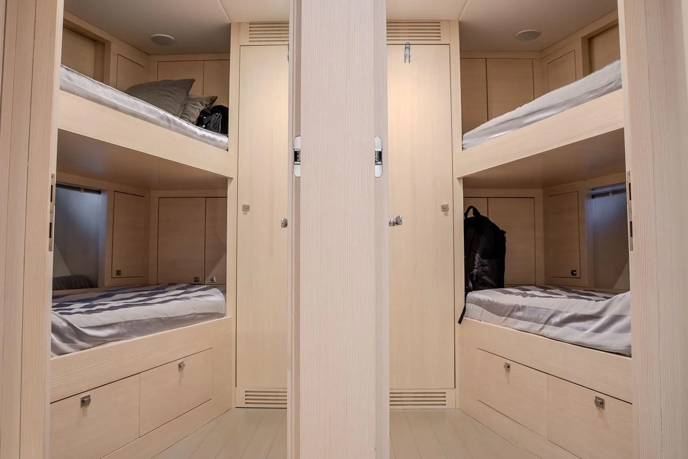 The yacht features a cozy bunk room with four neatly arranged beds and ample storage space. aboard SPECTRE Yacht for Sale