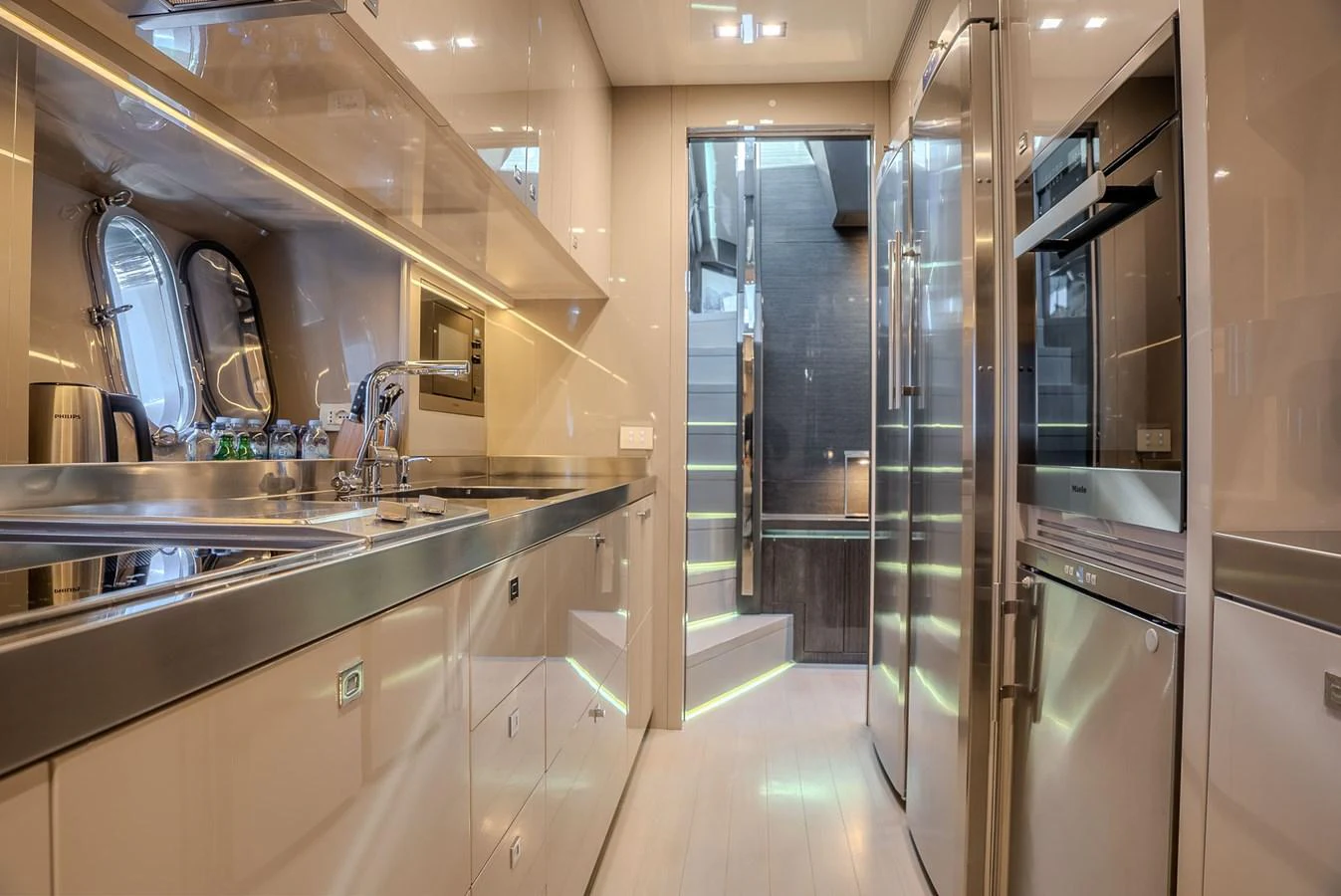 The yacht's galley is sleek and modern, featuring stainless steel appliances and ample storage space. aboard SPECTRE Yacht for Sale