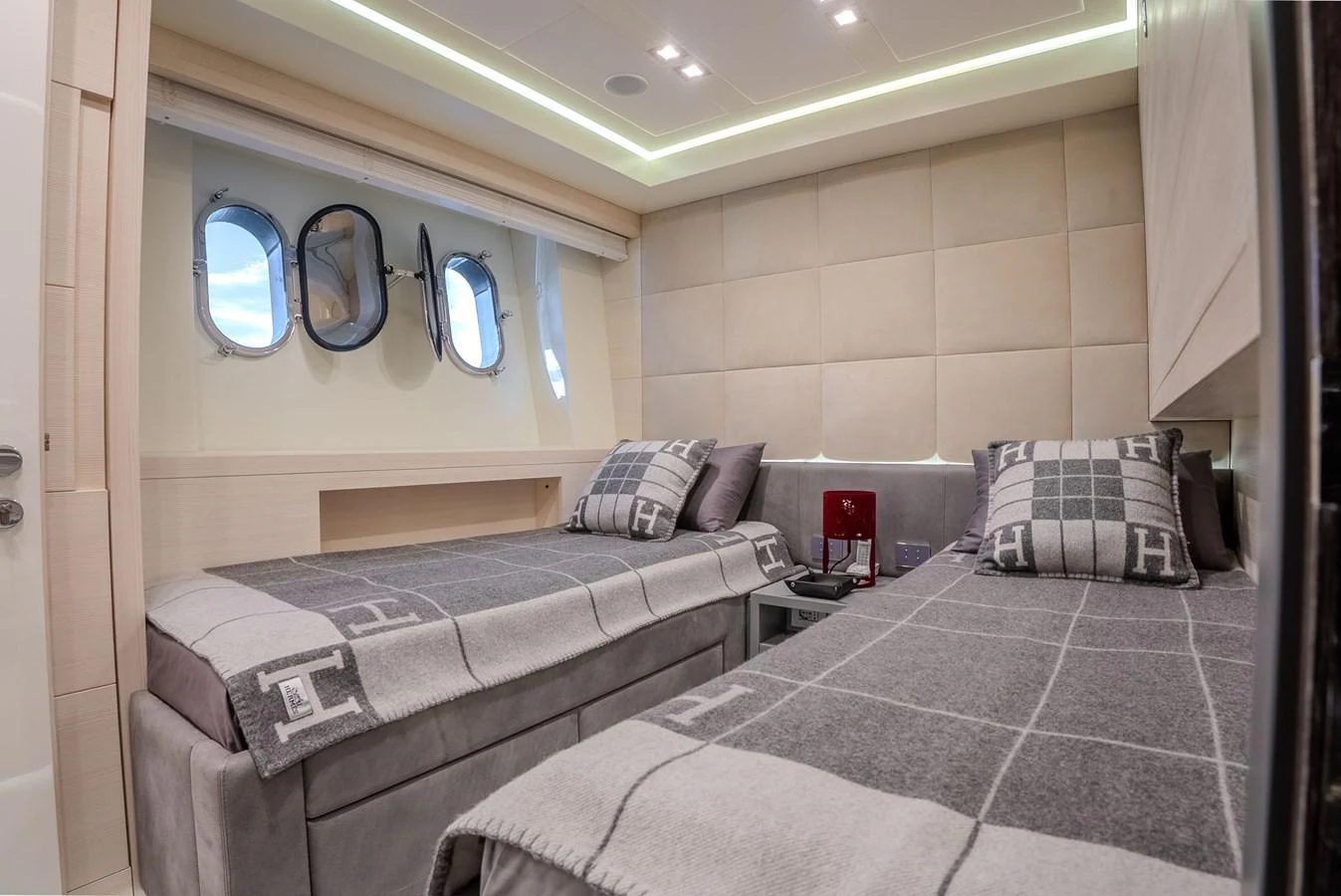 The guest stateroom features twin beds with luxurious bedding and a serene ambiance. aboard SPECTRE Yacht for Sale
