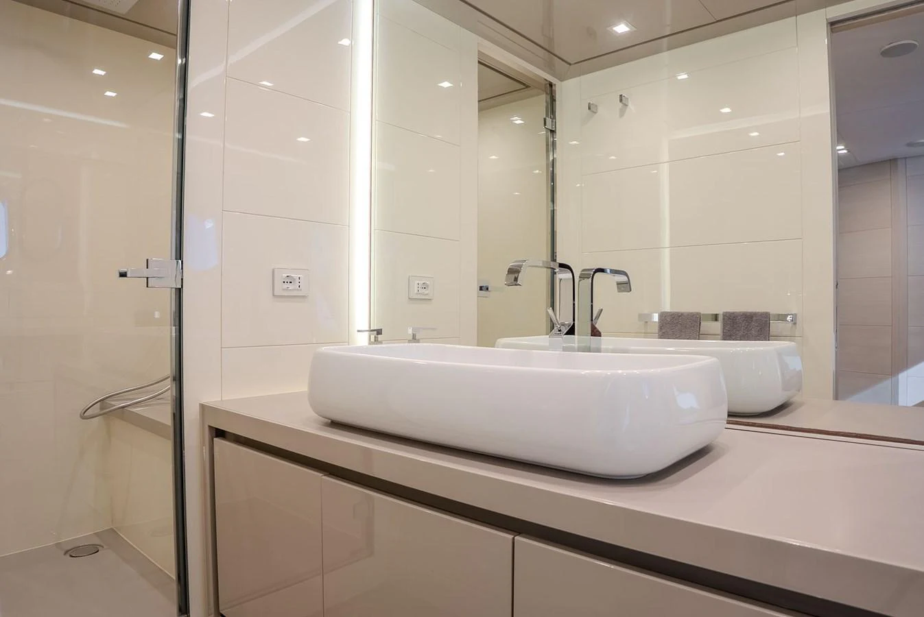 The yacht's bathroom features a sleek, modern design with a large basin sink and elegant fixtures. aboard SPECTRE Yacht for Sale