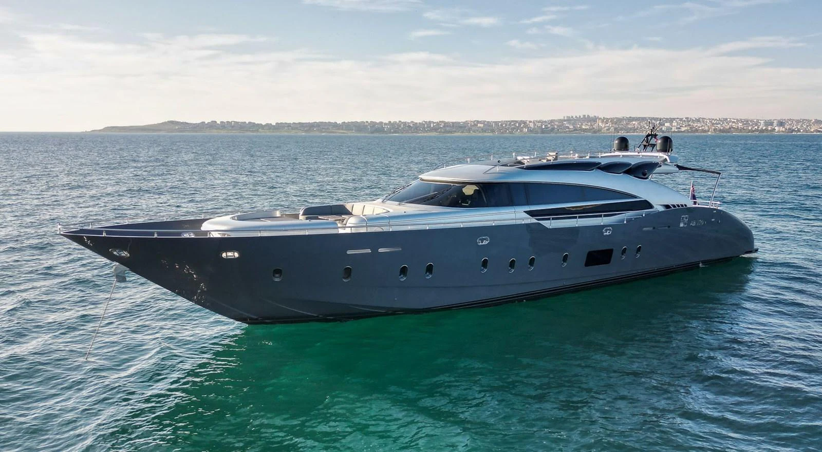 A sleek and modern yacht glides gracefully on the open water, showcasing its elegant design. aboard SPECTRE Yacht for Sale