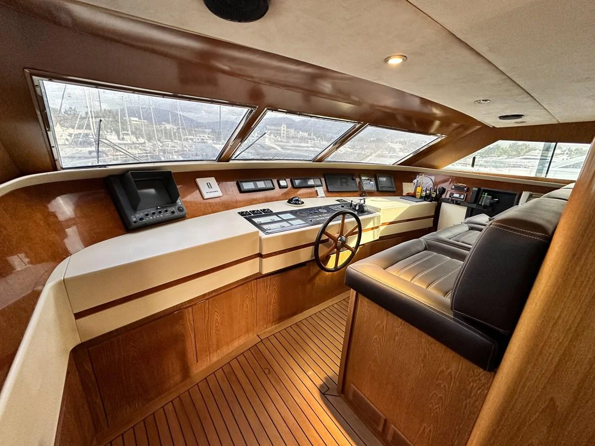 The helm station features a sophisticated design with wood accents and modern navigation equipment. aboard GALINI Yacht for Sale