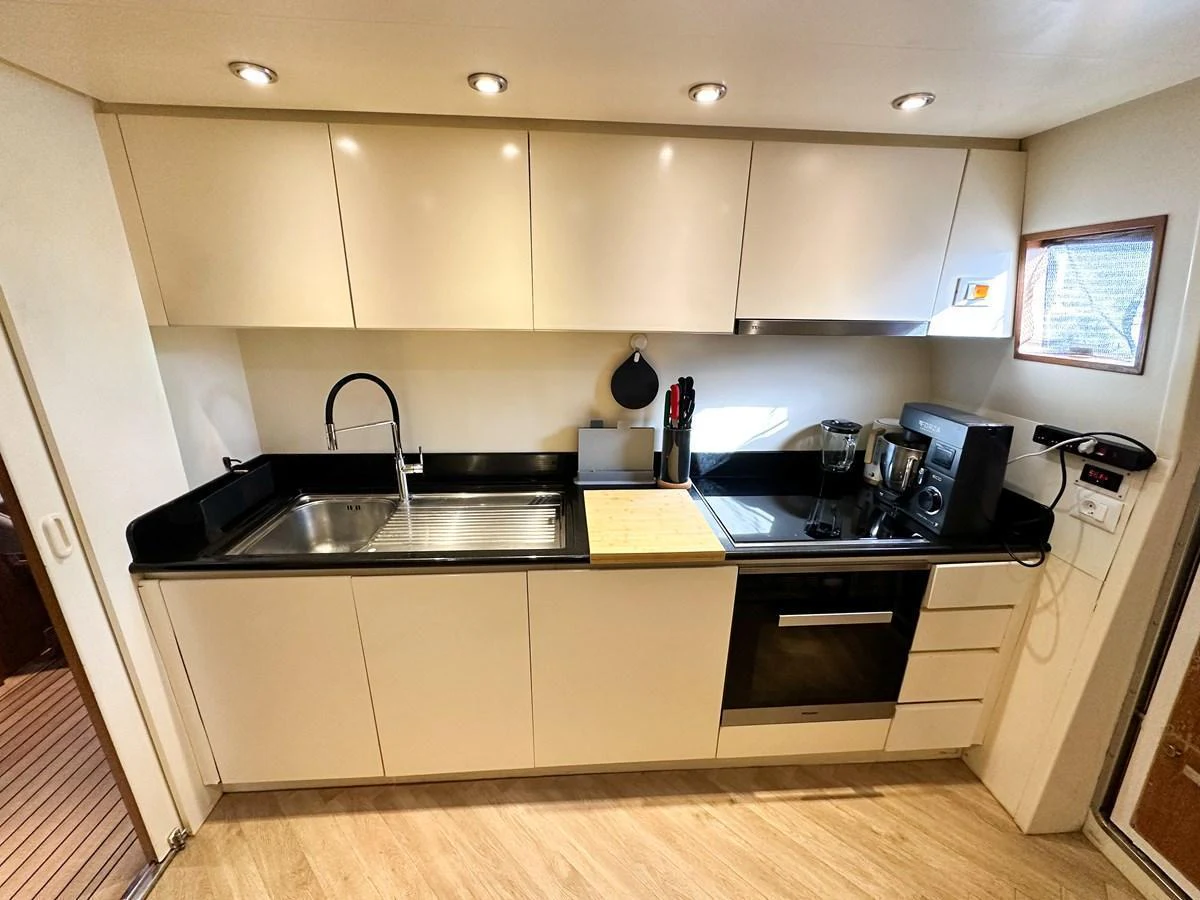 The yacht's galley features modern appliances and sleek cabinetry, creating a functional and stylish cooking space. aboard GALINI Yacht for Sale