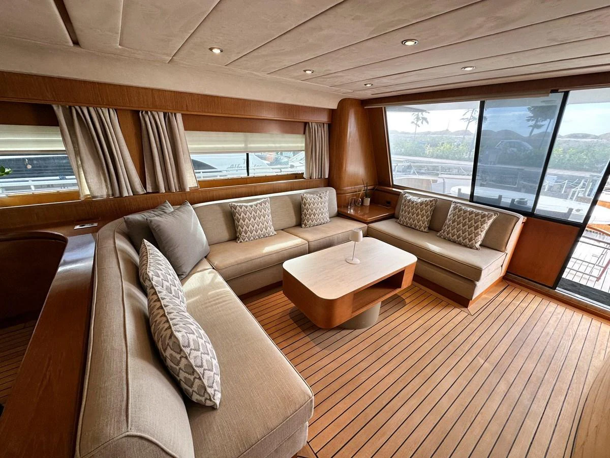 The salon features a spacious seating area with plush sofas and a modern coffee table, bathed in natural light from large windows. aboard GALINI Yacht for Sale