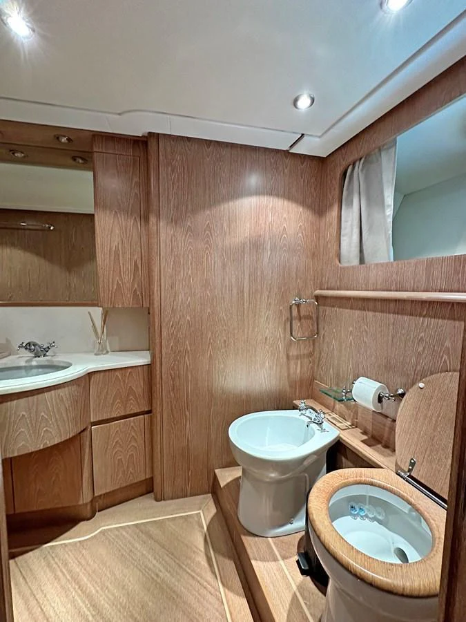 The yacht's bathroom features elegant wood paneling and modern fixtures. aboard GALINI Yacht for Sale