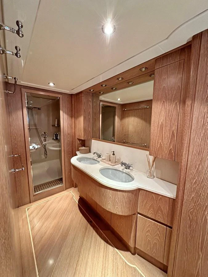 The yacht's bathroom features a double sink vanity with ample storage and a spacious shower area. aboard GALINI Yacht for Sale