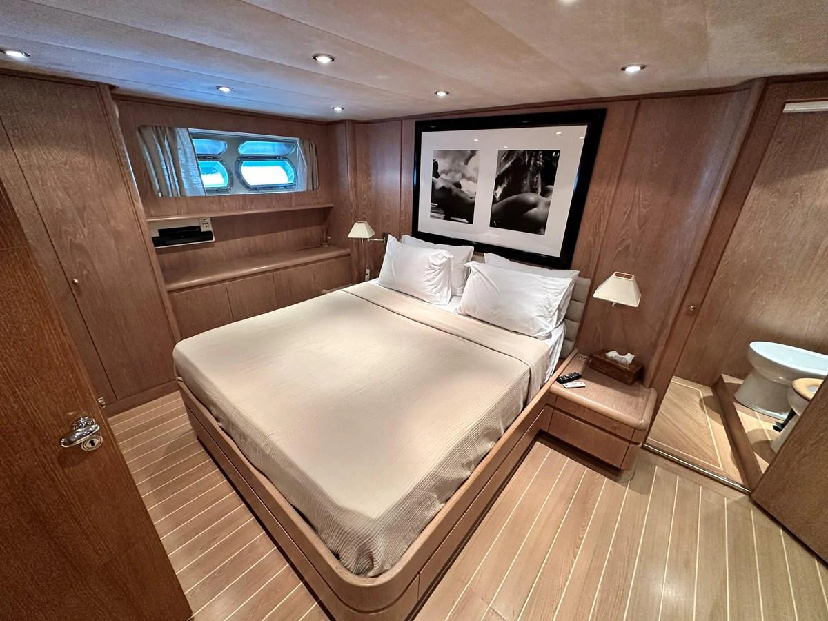 The stateroom features a comfortable double bed and elegant wooden furnishings. aboard GALINI Yacht for Sale