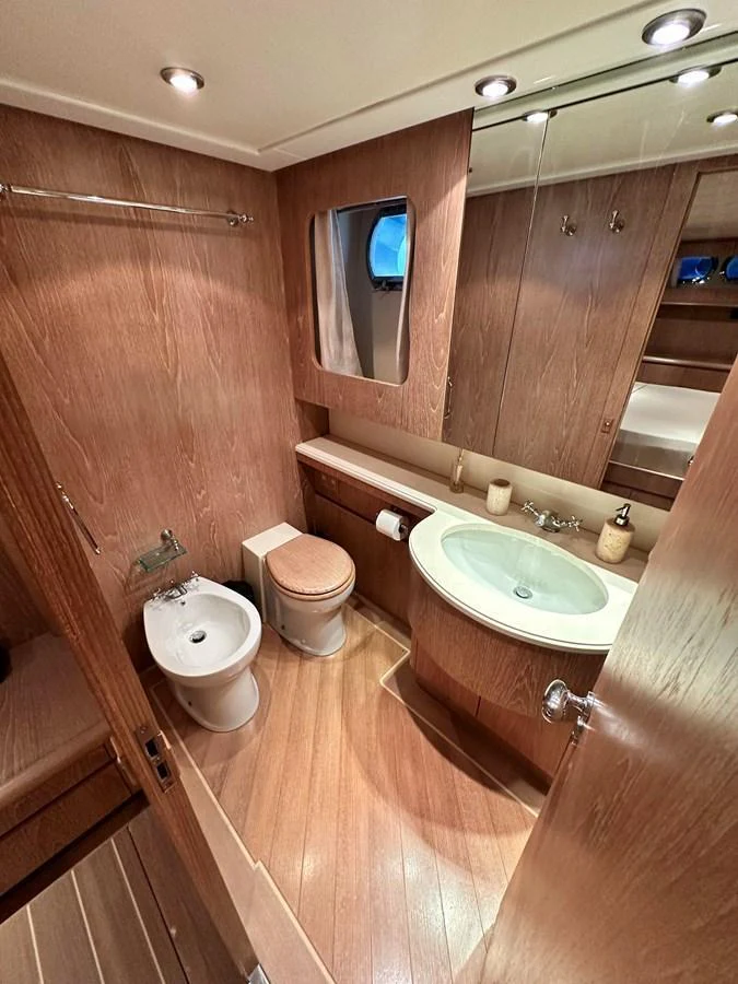 The yacht's bathroom features elegant wooden finishes and modern fixtures. aboard GALINI Yacht for Sale