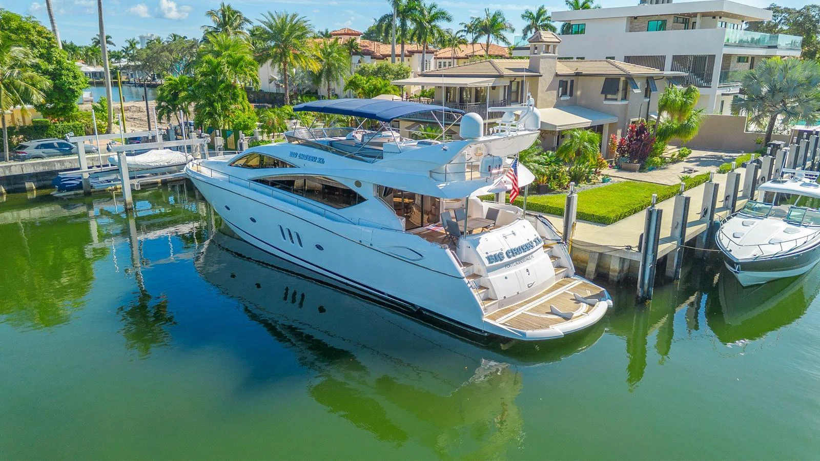 A sleek and modern yacht is docked in a serene marina, showcasing its elegant design and spacious decks. aboard BIG CHUBBY XL Yacht for Sale