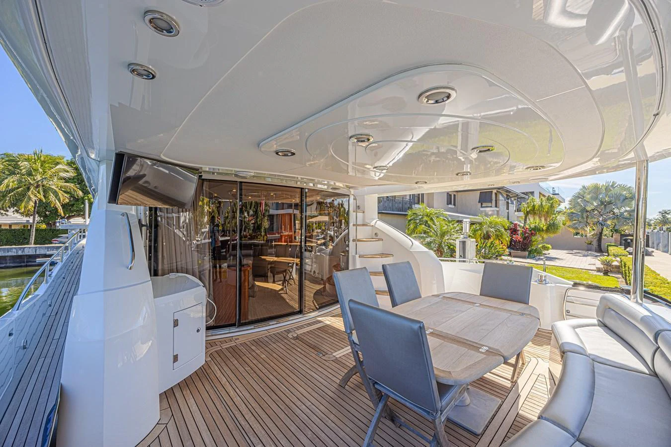 The aft deck features a spacious seating area with a dining table, perfect for alfresco meals and relaxation. aboard BIG CHUBBY XL Yacht for Sale