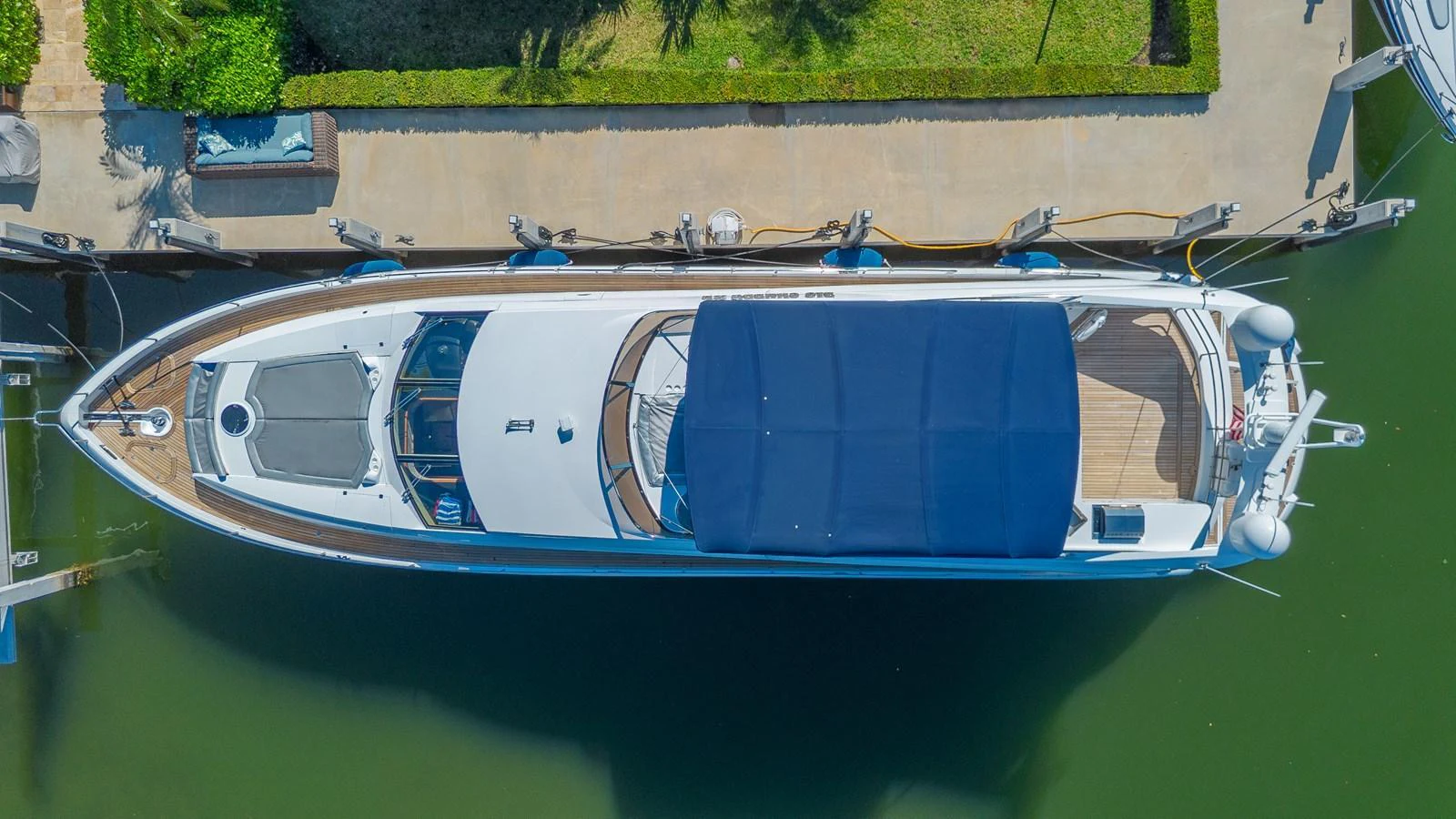 Aerial view of a sleek yacht docked at a marina, showcasing its spacious deck and elegant design. aboard BIG CHUBBY XL Yacht for Sale