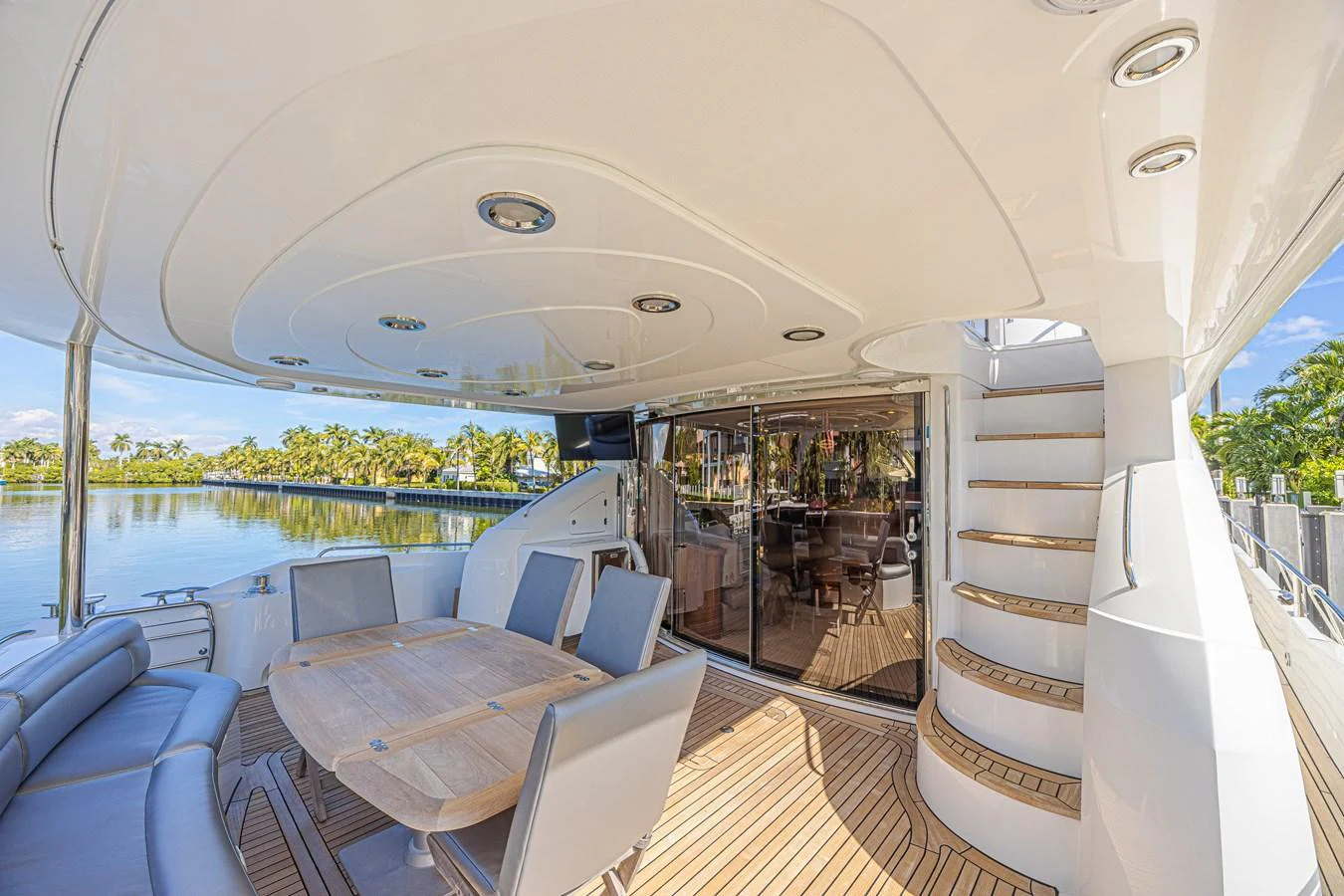 The aft deck features a spacious seating area with a dining table, perfect for al fresco meals and relaxation. aboard BIG CHUBBY XL Yacht for Sale
