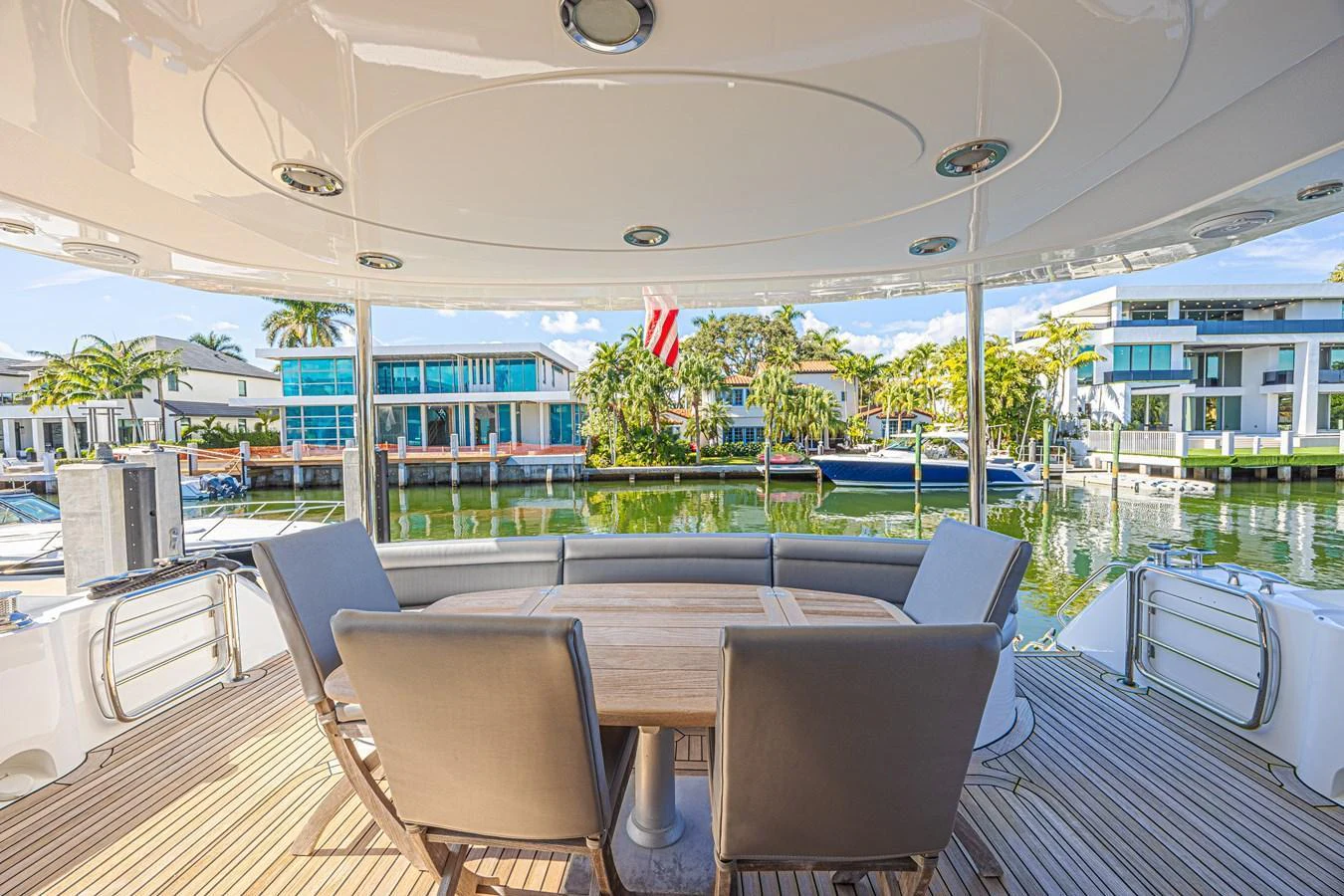 The aft deck features a stylish dining area with comfortable seating and a beautiful view of the marina. aboard BIG CHUBBY XL Yacht for Sale