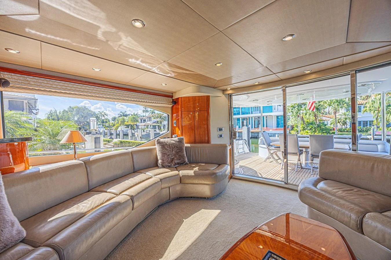 The salon offers a spacious and comfortable seating area with ample natural light and a view of the exterior deck. aboard BIG CHUBBY XL Yacht for Sale