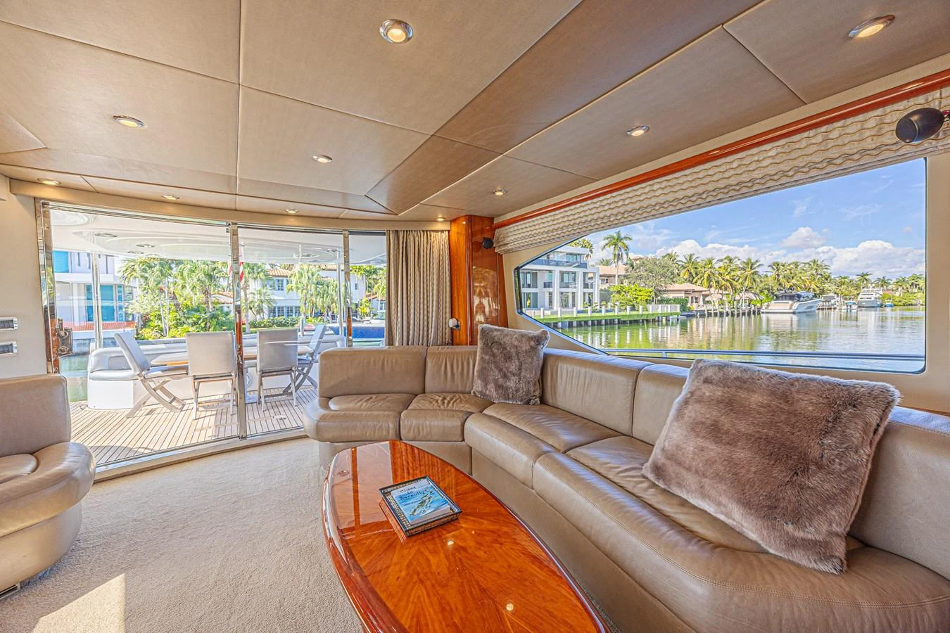 The salon offers a spacious and comfortable seating area with large windows providing stunning views of the water. aboard BIG CHUBBY XL Yacht for Sale