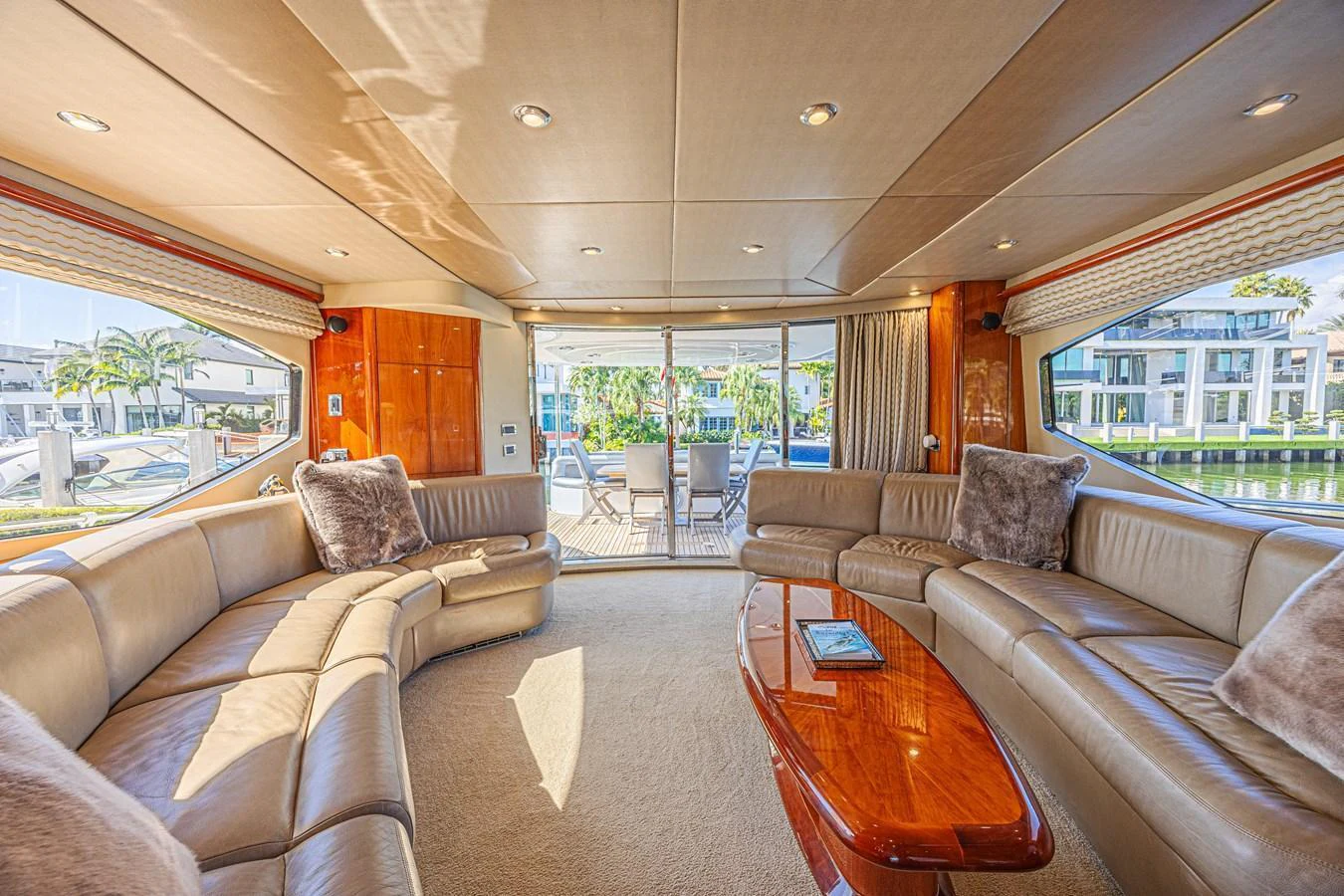 The salon features plush seating and a polished wooden table, offering a luxurious space for relaxation. aboard BIG CHUBBY XL Yacht for Sale