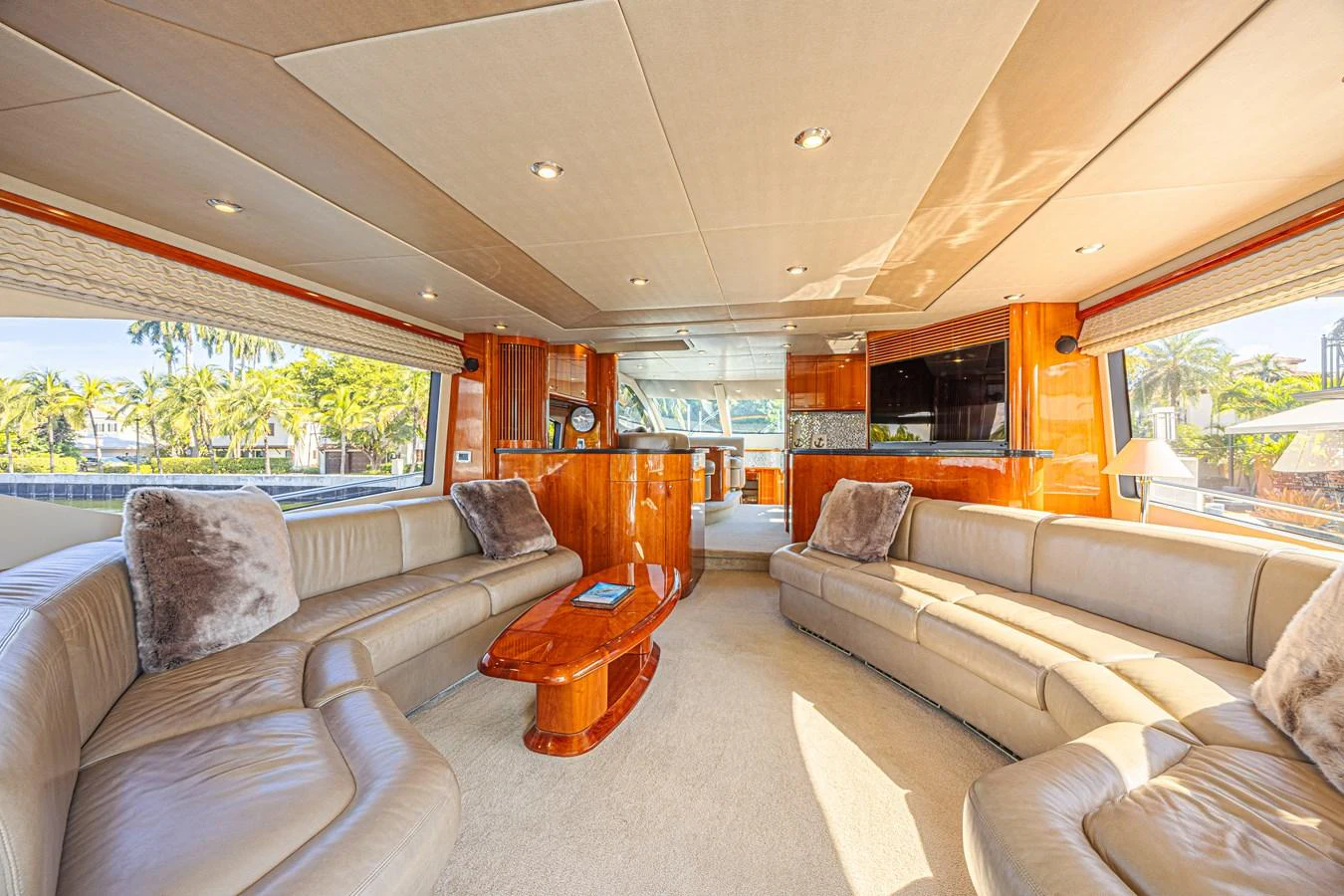 The yacht's salon features plush seating, warm wood accents, and ample natural light for a luxurious and inviting atmosphere. aboard BIG CHUBBY XL Yacht for Sale