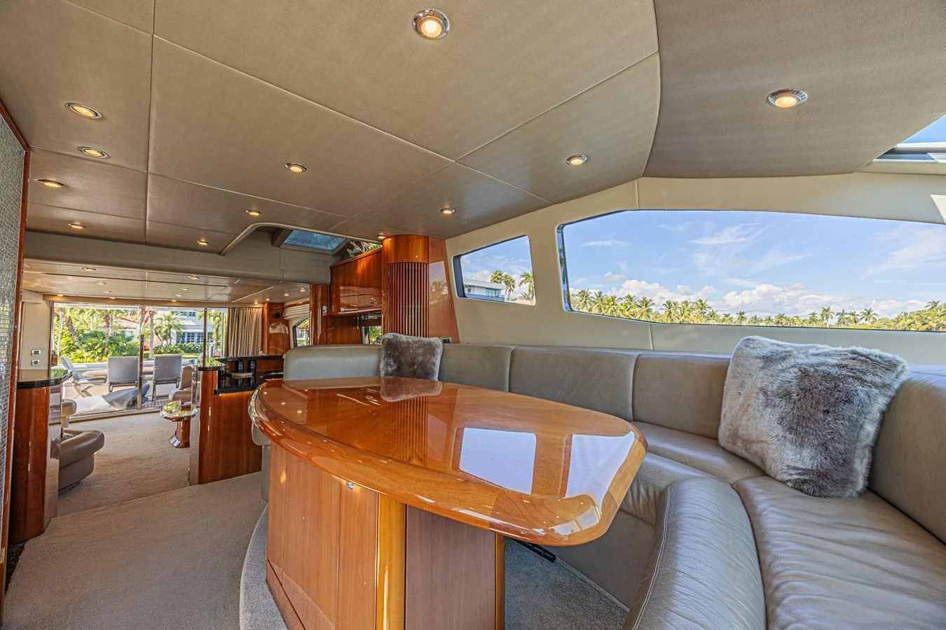 The yacht's salon features a luxurious seating area with plush cushions and a polished wooden table, offering a comfortable and elegant space for relaxation. aboard BIG CHUBBY XL Yacht for Sale