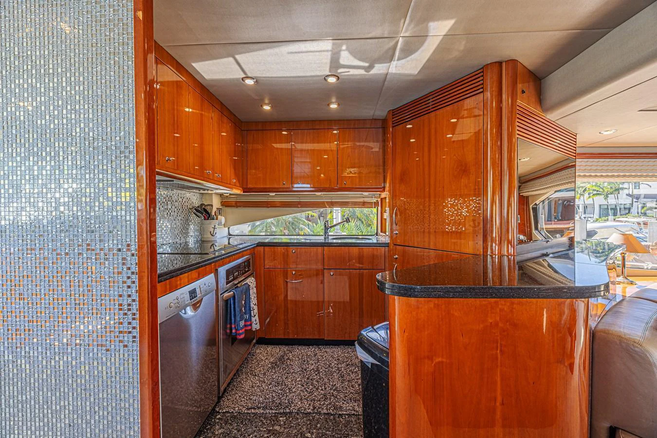 The yacht's galley features polished wood cabinetry, modern appliances, and ample counter space. aboard BIG CHUBBY XL Yacht for Sale