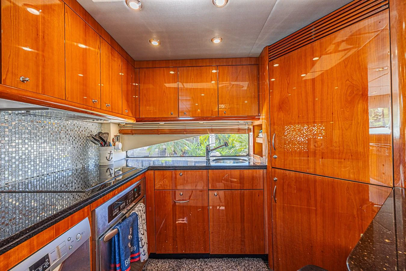 The galley features sleek wooden cabinetry and modern appliances, creating a warm and functional space for culinary endeavors. aboard BIG CHUBBY XL Yacht for Sale
