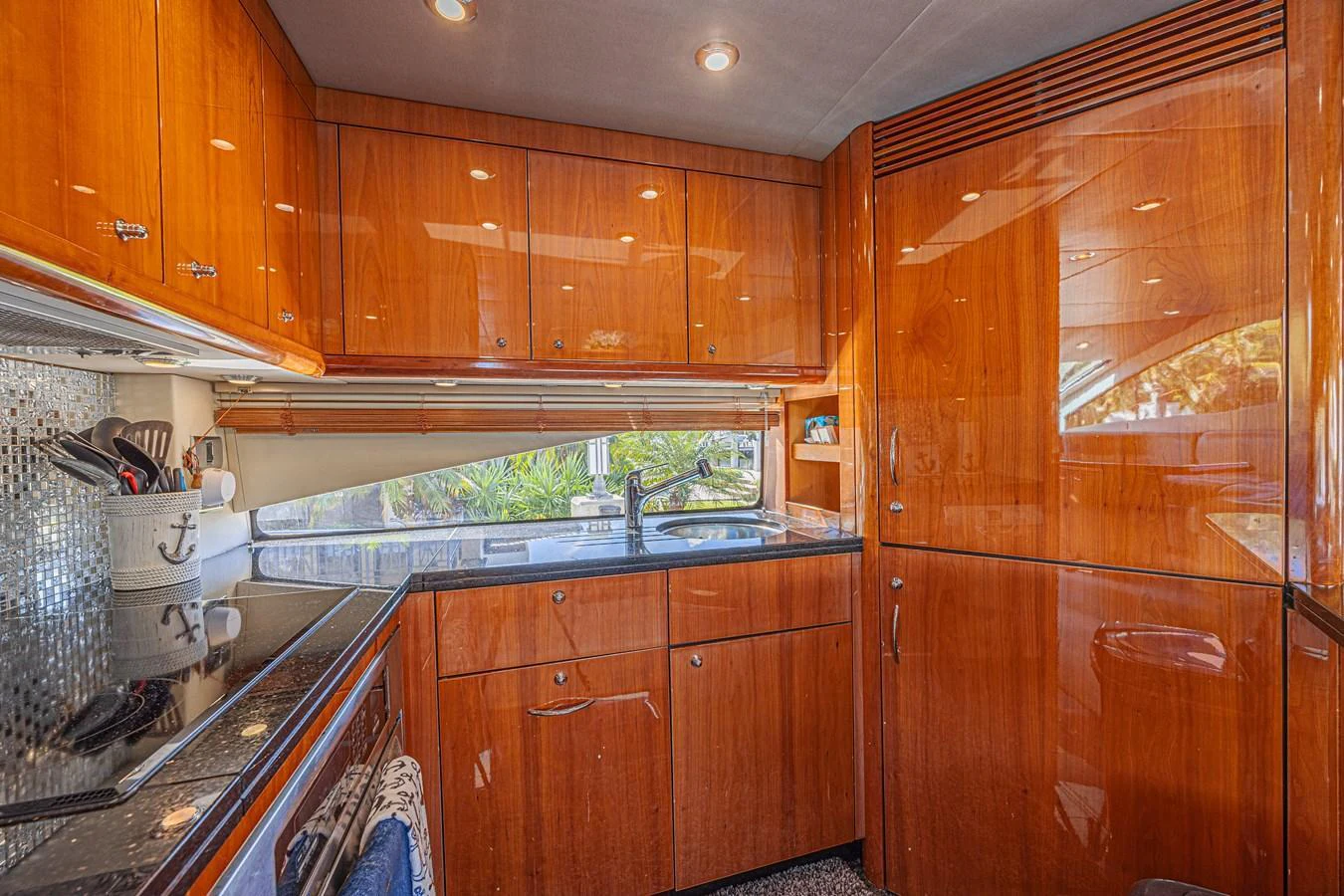 The yacht's galley features polished wooden cabinetry and modern appliances, creating a warm and functional space. aboard BIG CHUBBY XL Yacht for Sale