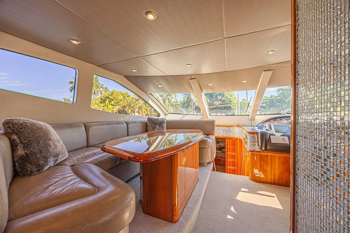 The salon features plush seating, a polished wooden table, and large windows offering a panoramic view. aboard BIG CHUBBY XL Yacht for Sale